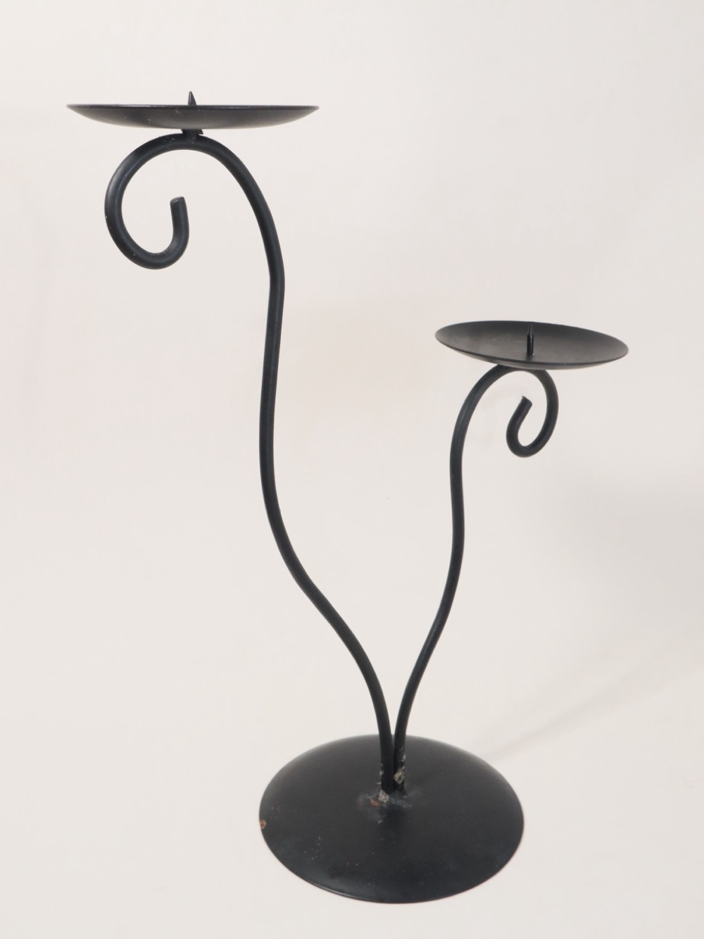 Vintage postmodern black metal double candle holder with a scrollwork design